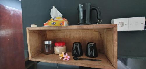 a wooden shelf with some items on it at Suba Homestay in Nusa Lembongan
