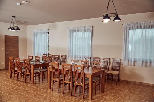 a large dining room with wooden tables and chairs at Vadvirág Vendégház in Izsák