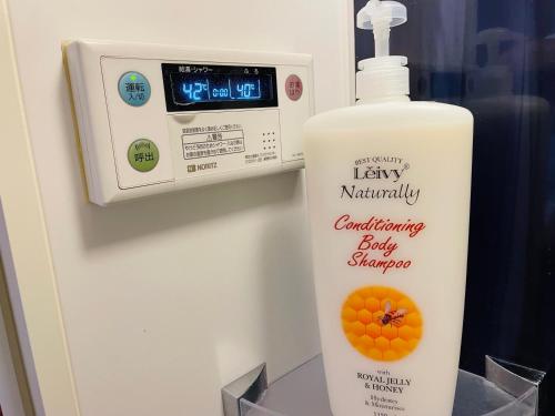 a bottle of laundry detergent next to a soap dispenser at Asakusa，2BR Cozy Detached House，10mins to Sensō-ji in Tokyo