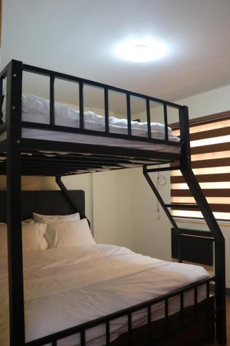 a bedroom with two bunk beds in a room at Anicia Guesthouse Rooms in Manila