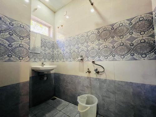 a bathroom with a sink and a toilet at TCS SUITES in Cochin