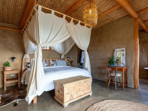 a bedroom with a canopy bed with a wooden ceiling at Goodluck Homestead in Stanford