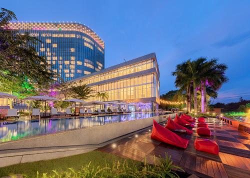a row of red canoes on a boardwalk next to a building at LOTTE Hotel Serviced Apartment in Yangon