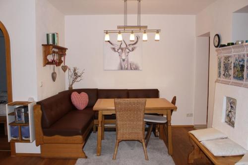 a living room with a couch and a table at Ferienwohnung Geigelsteinblick in Schleching