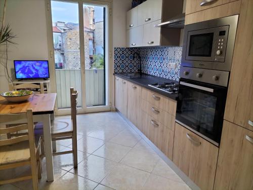 a kitchen with a table and a stove top oven at InCentro Palermo in Palermo