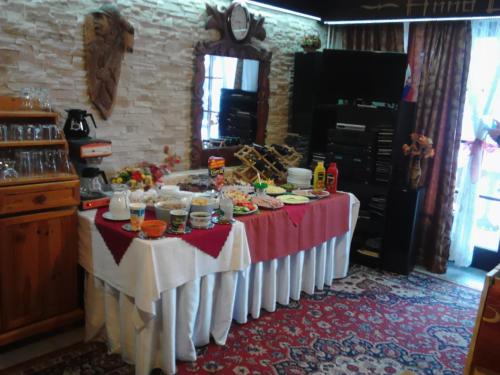 a table with food on it in a kitchen at Penzion Havran in Ždiar