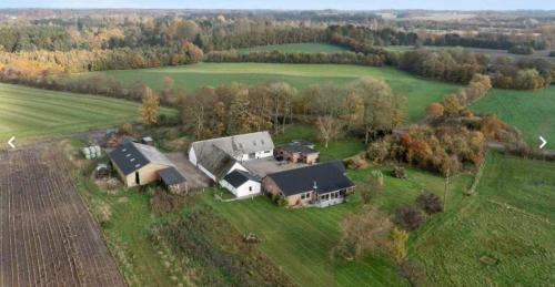 an aerial view of a large house in a field at Hyrdeskolen in Give