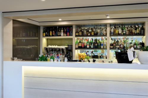 a bar with a lot of bottles of alcohol at Park Hotel Brasilia in Lido di Jesolo