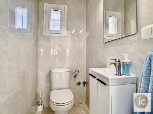 a bathroom with a toilet and a sink at La Vela Estartit Rental in L'Estartit