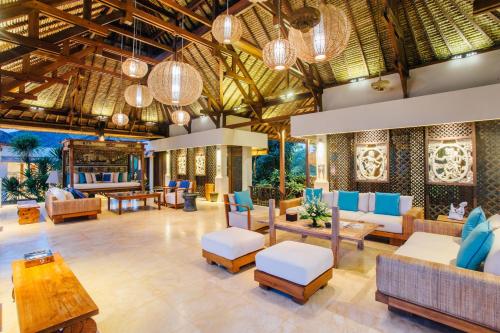 a lobby with couches and chairs and tables at Anapuri Villas in Ketewel