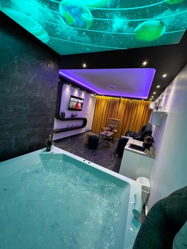 a bathroom with a tub and a room with a couch at Apartman S&V 3 Istocno Sarajevo Lukavica sa Jacuzzi Lux Spa Hilandarska Centar in Lukavica