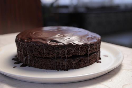a chocolate cake on a plate on a table at Tolip Olympia Hotel in Addis Ababa