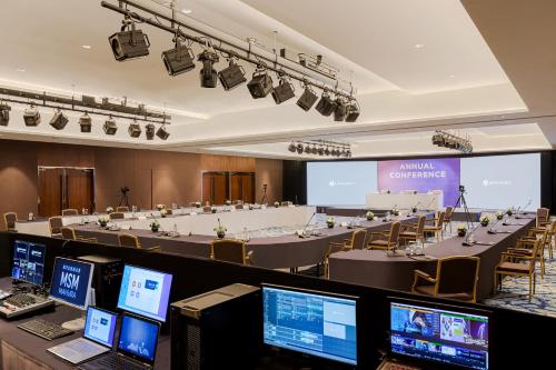 a large room with tables and laptops in it at LOTTE Hotel Serviced Apartment in Yangon