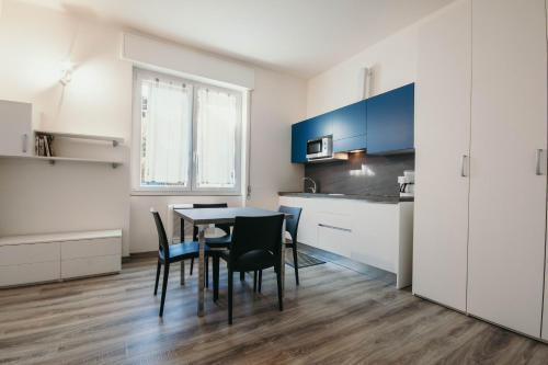 a kitchen and dining room with a table and chairs at AL 13 - Lakeside Leisure & Business in Stresa