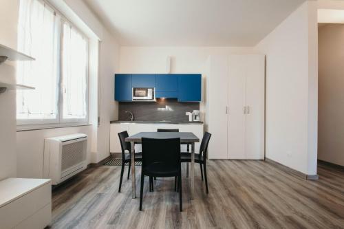 a kitchen and dining room with a table and chairs at AL 13 - Lakeside Leisure & Business in Stresa