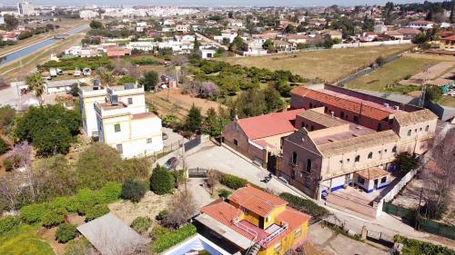an aerial view of a small town with buildings at Casa Cortijo Olivar in Seville
