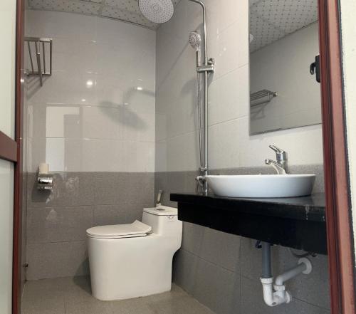 a bathroom with a toilet and a sink at Song Kieu Hotel - Self check-in in Ha Long