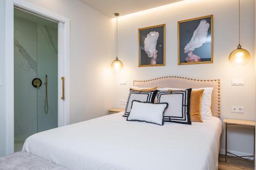 a bedroom with a white bed with two pillows at Machim D Arfet House by Homie in Machico