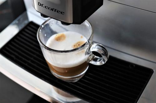 a coffee machine is making a cup of coffee at KSL ESPLANADE HOTEL with HOT SPRING in Klang