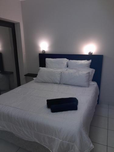 a bed with a black pillow on top of it at Cabanas Del Mar 31 in Kingsborough