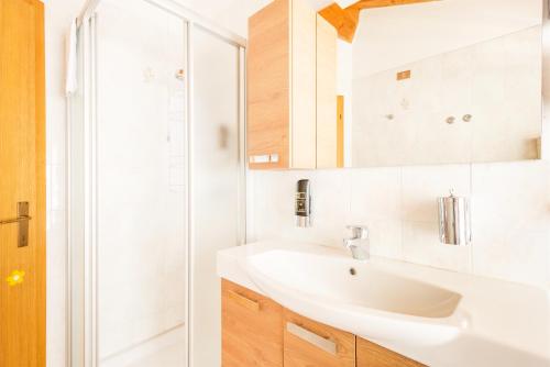 a white bathroom with a sink and a shower at CROSINA HOLIDAY - Casa Lucia in Ledro