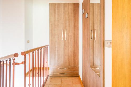 a hallway with wooden cabinets and a staircase at CROSINA HOLIDAY - Casa Lucia in Ledro