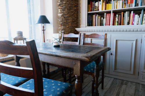 a dining room with a wooden table and chairs at Beachhotel Cuxhaven in Cuxhaven