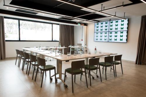 a large conference room with a long table and chairs at Mercure Roma Cinecittà in Rome