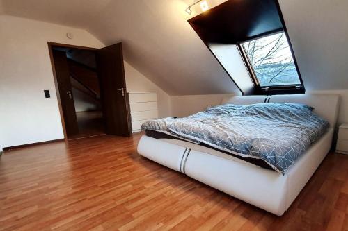 a bedroom with a bed and a window on the ceiling at Studiowohnung SchwabenALB mit Panoramablick in Albstadt