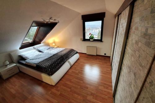 a bedroom with a bed and a window in a room at Studiowohnung SchwabenALB mit Panoramablick in Albstadt
