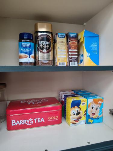 a shelf with a red box and other products on it at The Old House at Belfield in Tralee