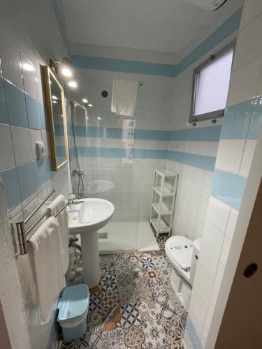 a bathroom with a sink and a toilet at HOSTAL LA CRUZ 1872 in Chipiona