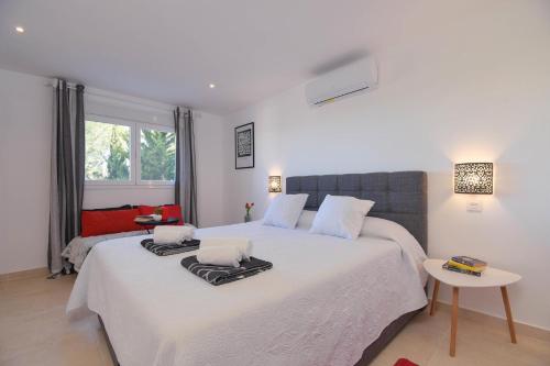 ein Schlafzimmer mit einem großen Bett mit zwei Handtüchern darauf in der Unterkunft Amarige in Benitatxell