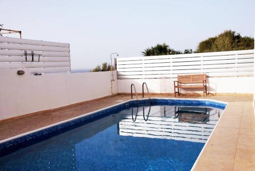 a swimming pool on the side of a house at Villa Only 50m To The Sea, Sleeps 12, Polis in Pomos