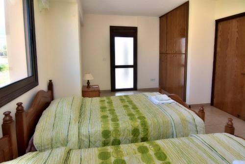 a bedroom with two beds and a window at Villa Only 50m To The Sea, Sleeps 12, Polis in Pomos