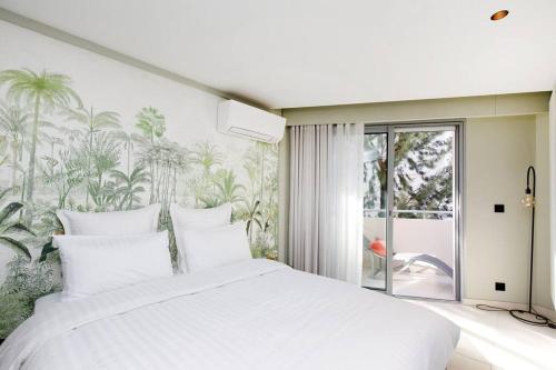 - une chambre dotée d'un lit blanc et d'une fresque murale sur les palmiers dans l'établissement Marriott area superb 1 bedroom, à Cannes