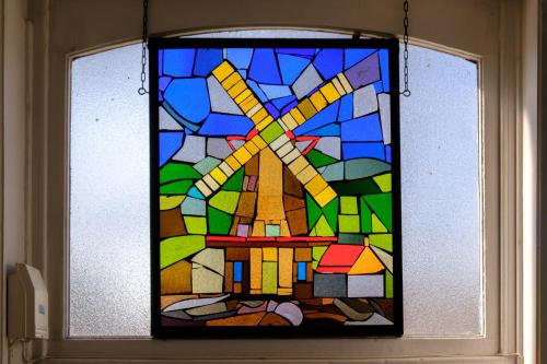 a stained glass window with a cross on it at Collier's BnB in Bruges