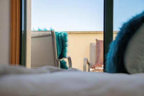 a room with a chair and a window at Luxury Singular Apartments Green in Santiago de Compostela