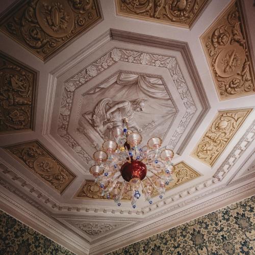 a ceiling with a chandelier in a room at Salotto delle Arti in Modena