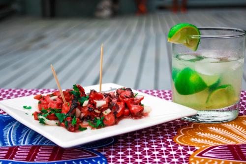 a plate of food and a drink on a table at Casa Cantagalo - Guest House & Bar Restaurant in Santana