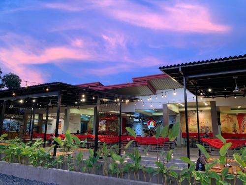 a restaurant with red tables and chairs at night at Balay Inato Pension in Puerto Princesa City