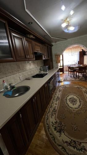 a kitchen with a sink and a counter top at Просторі та комфортні апартаменти «Д.І.М.» in Kamianets-Podilskyi