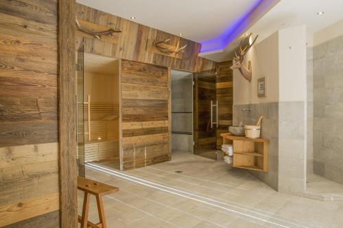 a bathroom with wooden walls and a walk in shower at Princess Bergfrieden in Seefeld in Tirol