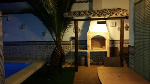 a house with a swimming pool and a fireplace at CASA RURAL EL ESCUDERO in El Toboso