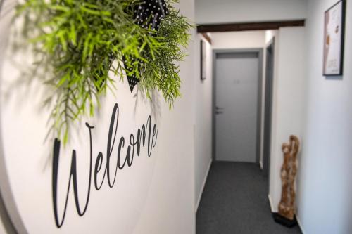 a hallway with plants on the wall at Hotel Dolce Vita in Balatonkenese