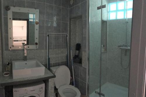 a bathroom with a toilet and a sink and a shower at Cap Agde Studio-Cabine jardin clos, port et plage in Cap d'Agde