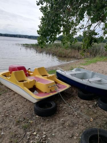 two boats parked on the shore of a body of water at Pod Sową in Drawsko Pomorskie