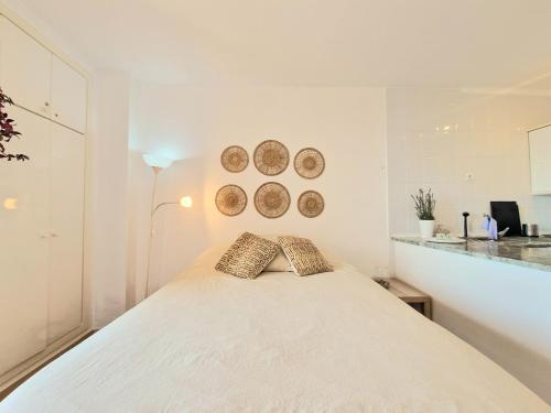 a bedroom with a bed with two pillows on it at AA Guest - The Golden Sea Views Eco Apartment in Benalmádena