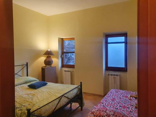 a bedroom with a bed and a window at Casa di Nonna Luciana 