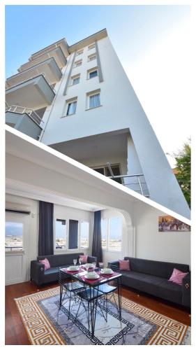 a living room with a couch and a table in front of a building at BİLGİNER APART in Demre